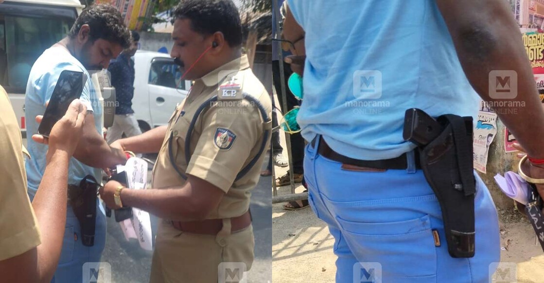 Police takes Murugan into custody after he protested against the drinking water disruption at the Venganur village officen with a gun.  Photo: Manorama