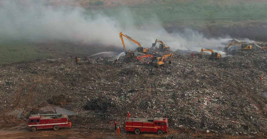 Fire & Rescue personnel engaged in the activity of putting out the fumes rising from the Brahmapuram waste dump yard. Photo: Manorama