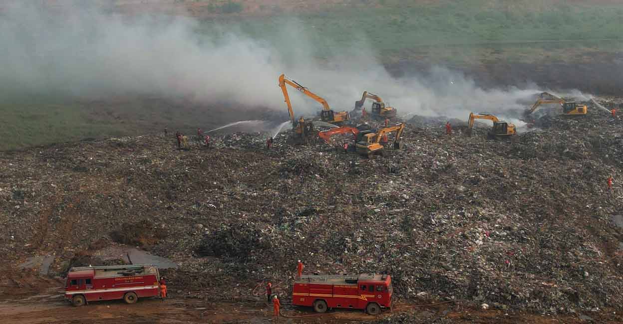 Fire & Rescue personnel engaged in the activity of putting out the fumes rising from the Brahmapuram waste dump yard. Photo: Manorama