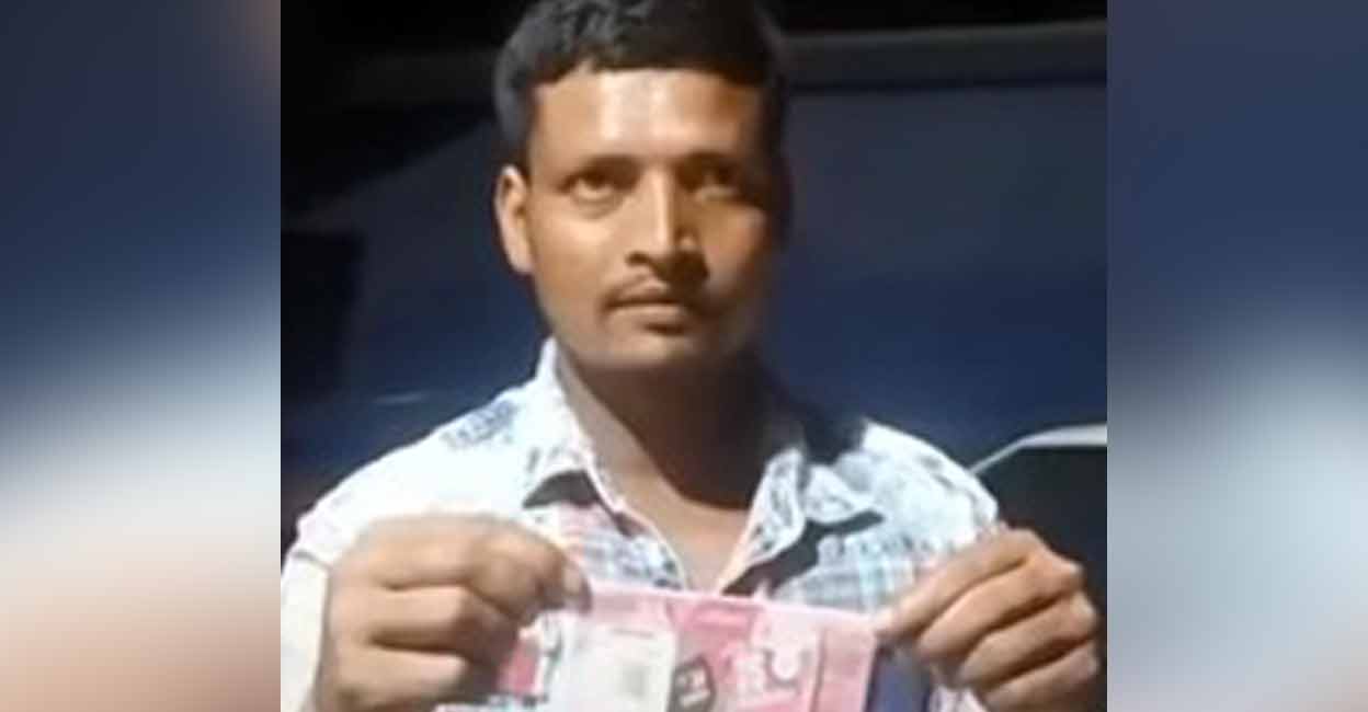 migrant-worker-lottery-win SK Badesh holds up his prize-winning lottery ticket. Photo: Shared by Kerala Police