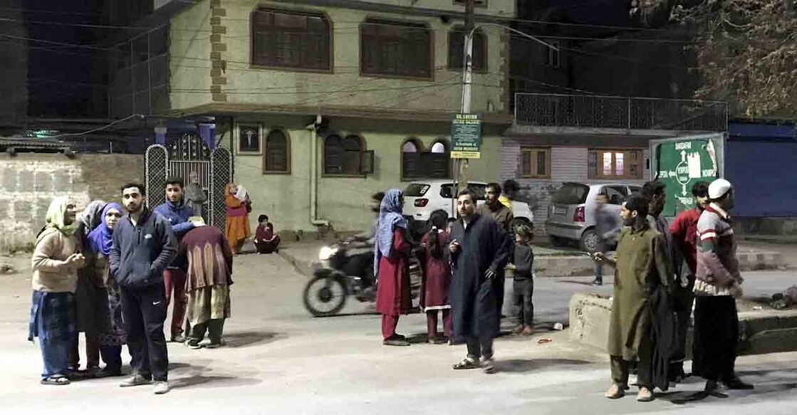 People gather outside their homes after tremors were felt due to an earthquake, in Srinagar, Tuesday, March 21, 2023. Photo: PTI