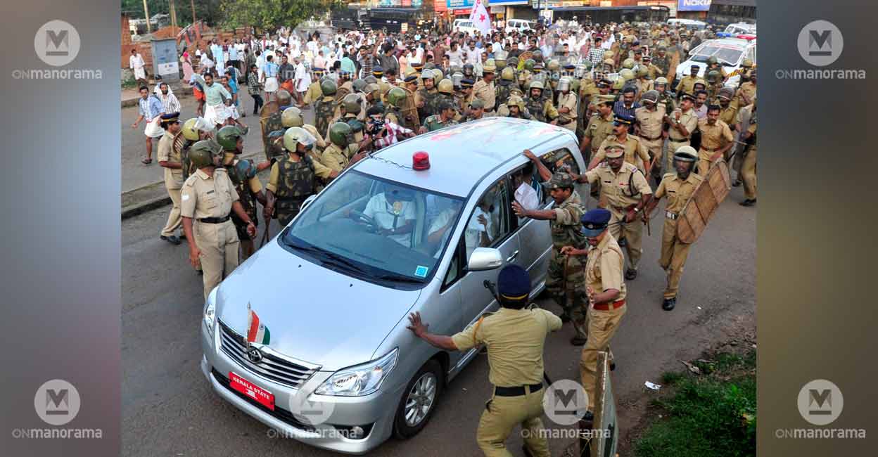 cm-oommen-chandy-car-attack The police shield the chief minister's car from stone pelting in Kannur on October 27, 2013. File photo: Manorama