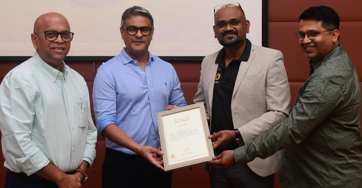 (From left) Varghese Chandy, vice president, marketing, advertising and sales, Malayala Manorama; Riyadh Mathew, chief associate editor, Malayala Manorama, Vinod Subramanian, Kerala business head, Trends; and Jayadevan Unni, Kerala marketing head, Trends with the Limca Book of Records certificate for the largest flower carpet in India. Photo: Manorama