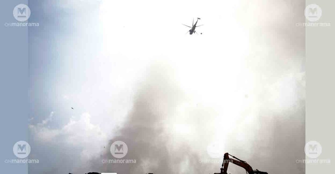 A chopper of the Indian Navy tries to extinguish the fire at Brahmapuram waste plant. Photo: I & PRD