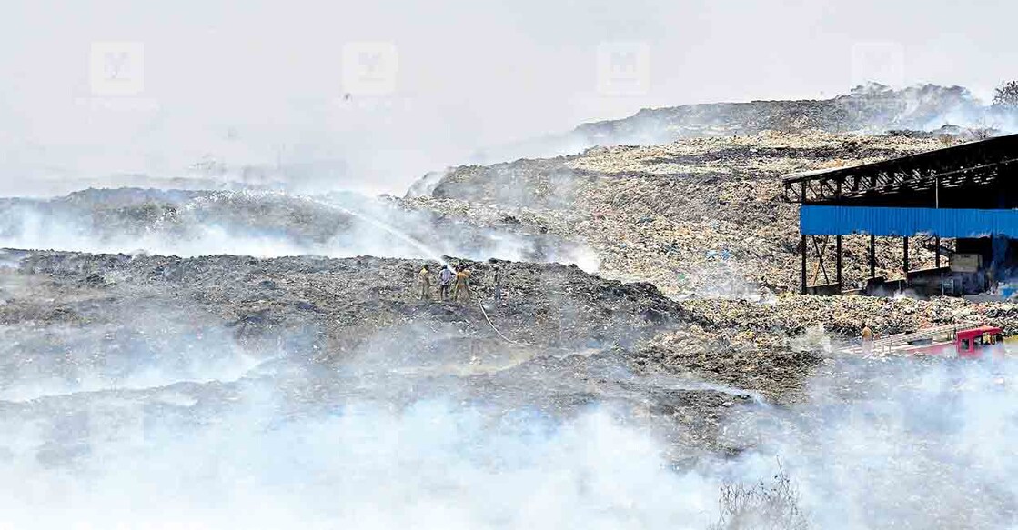 Plumes of smoke rise at Brahmapuram solid waste plant as firefighters try to douse the fire. Photo: Manorama