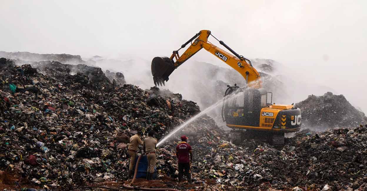 Firefighters engaged in dousing the fire at Brahmapuram waste dump yard near Kochi on Monday. Photo: PRD