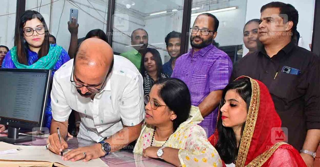 C Shukkur and his wife Sheena at the Kanhangad Hosdurg Sub-Registrar's office in the presence of their daughters. Photo: Jibin Chembola/Manorama