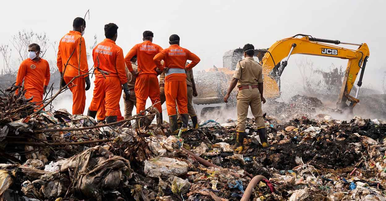 Fire & Rescue personnel engaged in putting out the fire at Brahmapuram waste dump yard. Photo: PRD