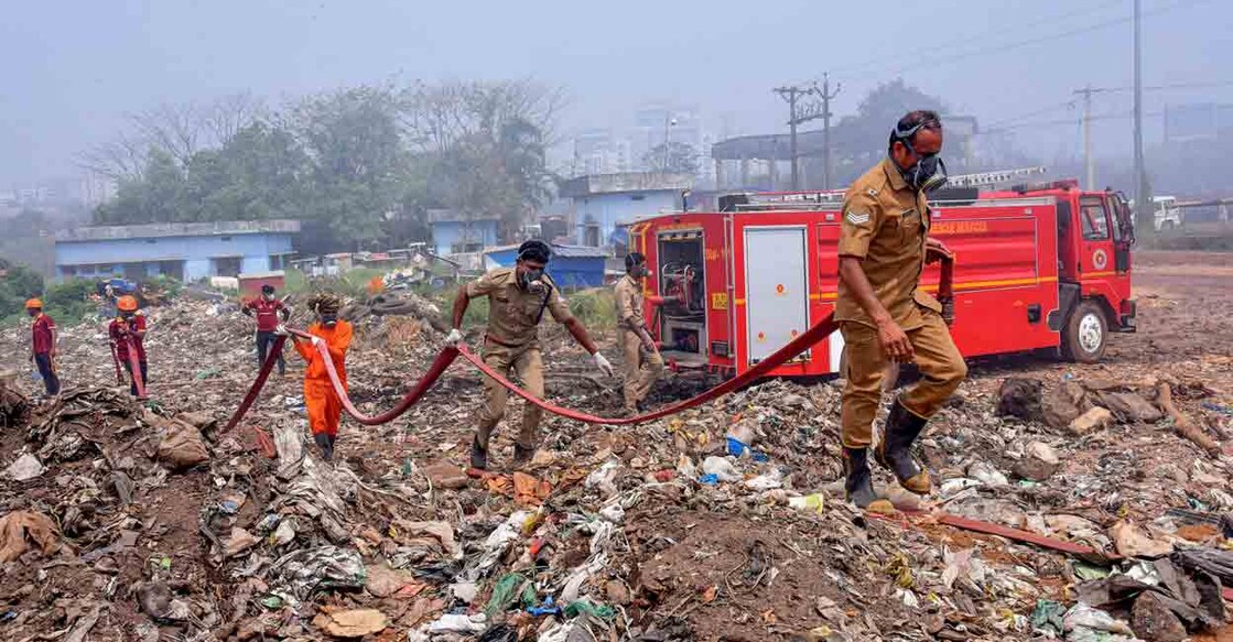 Fire and rescue personnel try to put out the fire which broke out at the Brahmapuram waste treatment plant, in Kochi, Sunday, March 5, 2023. Photo: PTI
