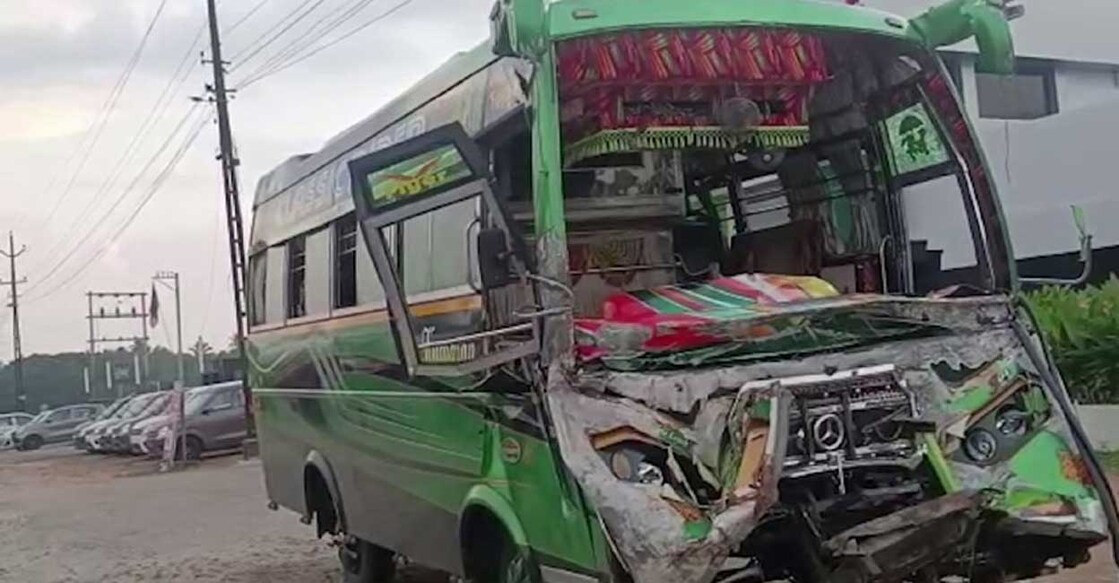 thrissur-accident A tourist bus crashed into a parked lorry on the highway in Thrissur. Photo: Manorama News
