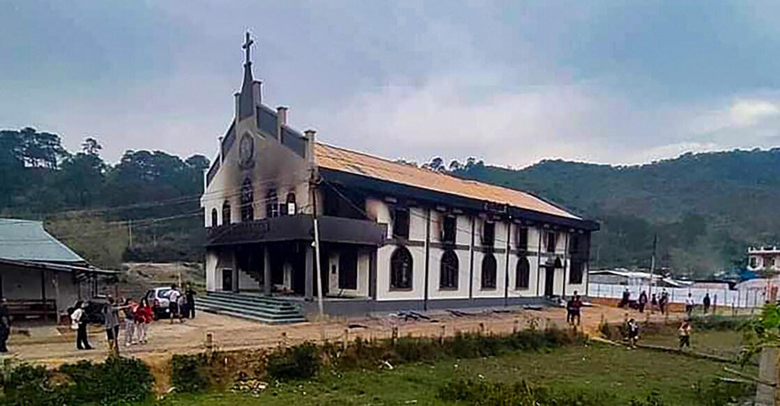 Smoke billows out from a church after violence broke out during the 'Tribal Solidarity March' called by All Tribal Student Union Manipur (ATSUM), in Imphal on May 4. Photo: PTI