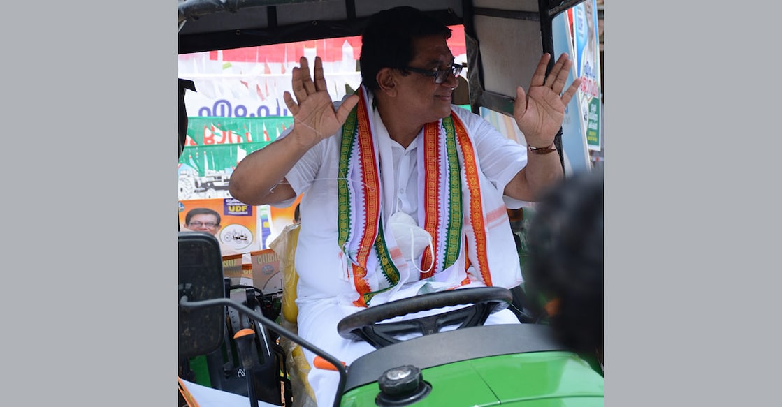 mpjoseph-1 UDF candidate in Trikaripur segment M P Joseph sitting on a tractor, his election symbol, during campaigning at Thimiri in Cheemeni. Photo: Onmanorama