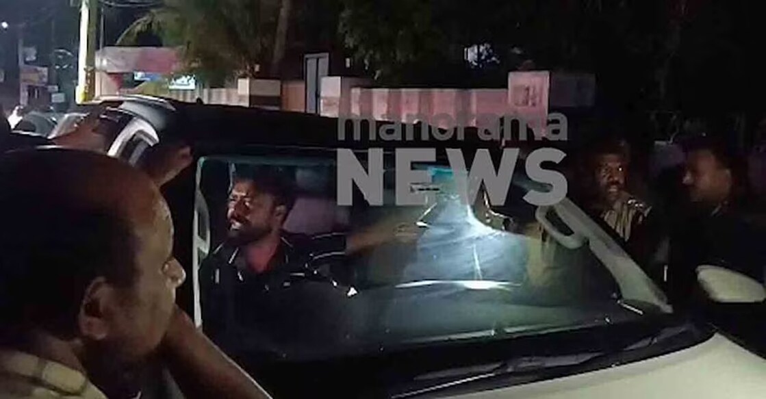 abduction-policemen-arrested The businessman, who had been handcuffed to his car, was rescued by locals and policemen. Photo: Screengrab/Manorama News