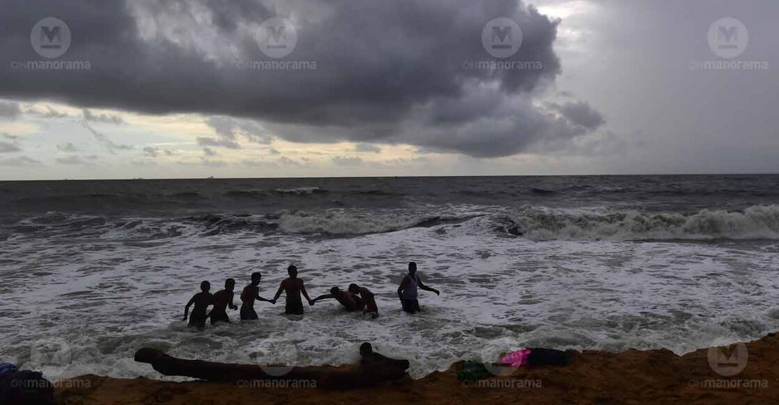 People play at Puthuvype Beach in Ernakulam as rain clouds gather over the ocean. Photo: Robert Vinod/Manorama