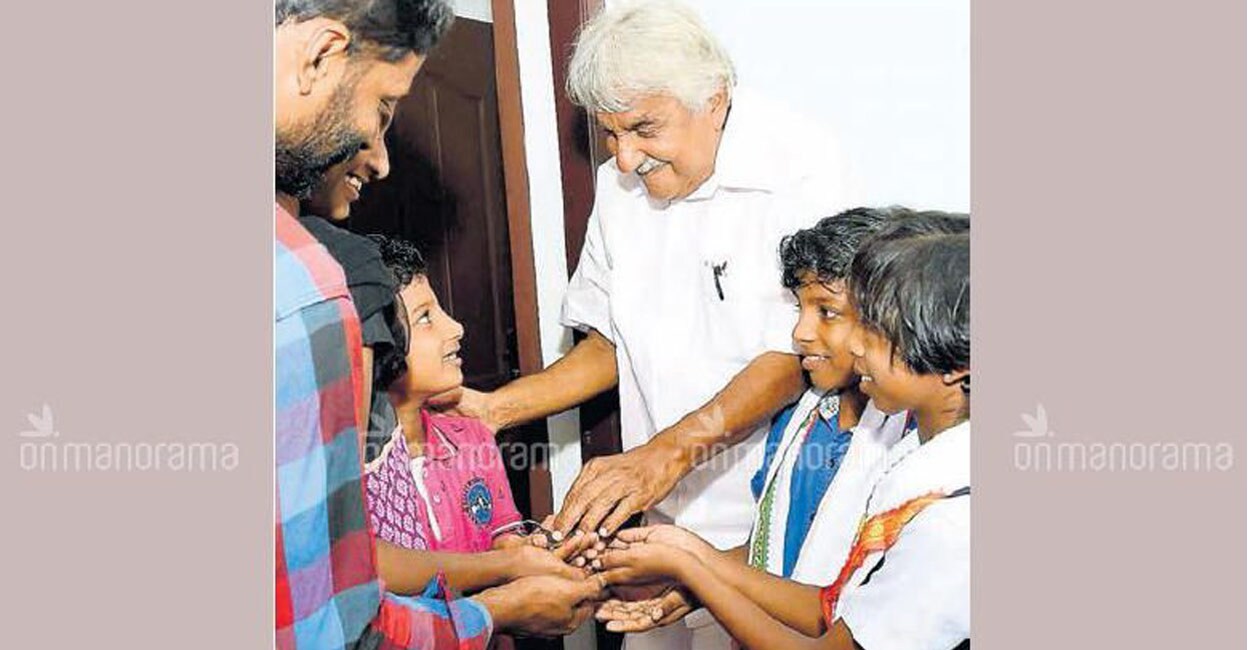Chandy handing over the key to the house to Krishna. Photo: Manorama