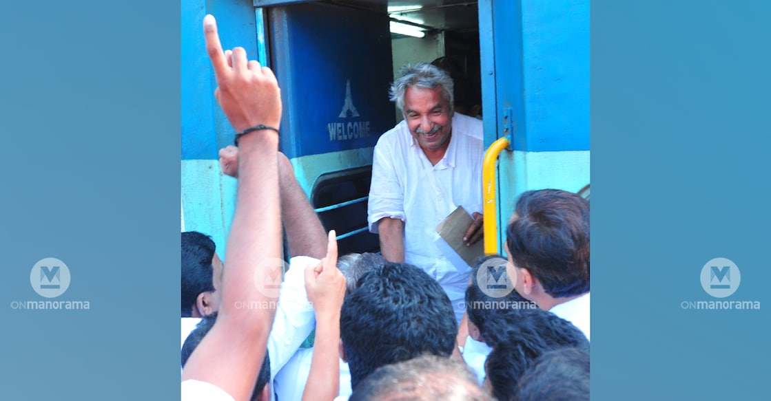 Oommen Chandy is received by supporters as he exits a train in Kannur. File photo: Manorama