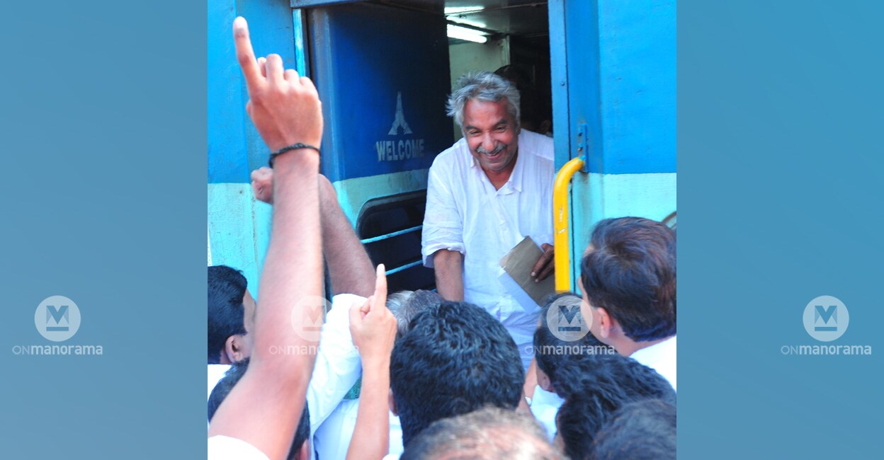 Oommen Chandy is received by supporters as he exits a train in Kannur. File photo: Manorama