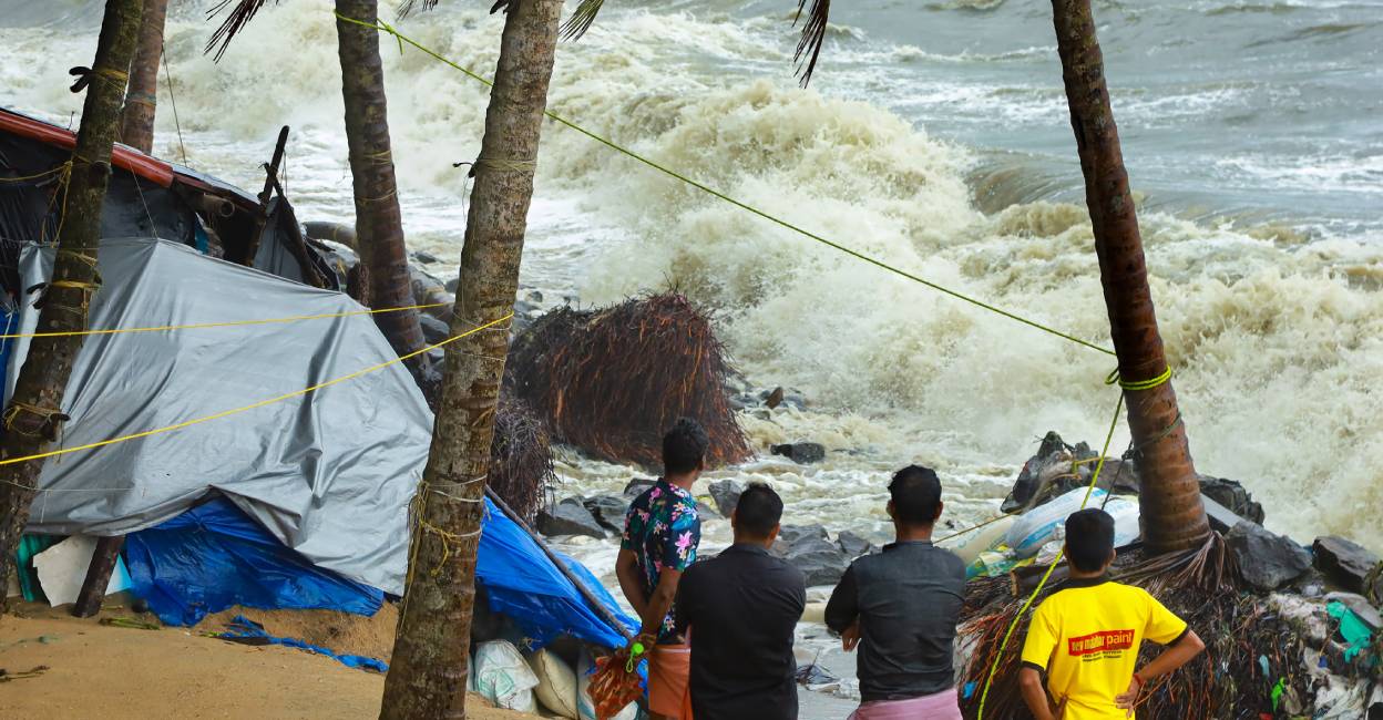 Sea incursion Locals gather near the debris of a house on the beach that was damaged by the rough sea during the ongoing monsoon season, in Kozhikode. Photo: PTI