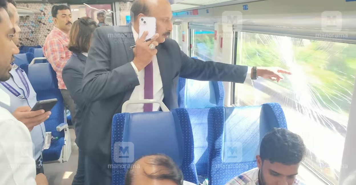 A railway official inspects the glass shattered by the stone pelting.