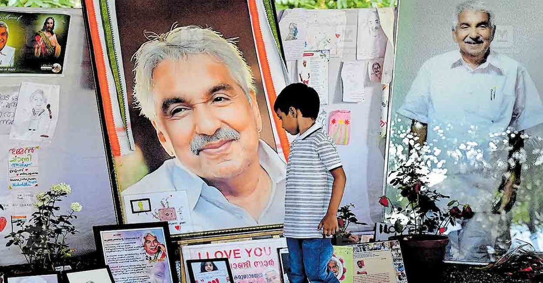 oommen-chandy-5 A boy looks at the pictures and messages placed near the tomb of former Chief Minister Oomen Chandy at St George's Orthodox Church at Puthuppally. Photo: Manorama