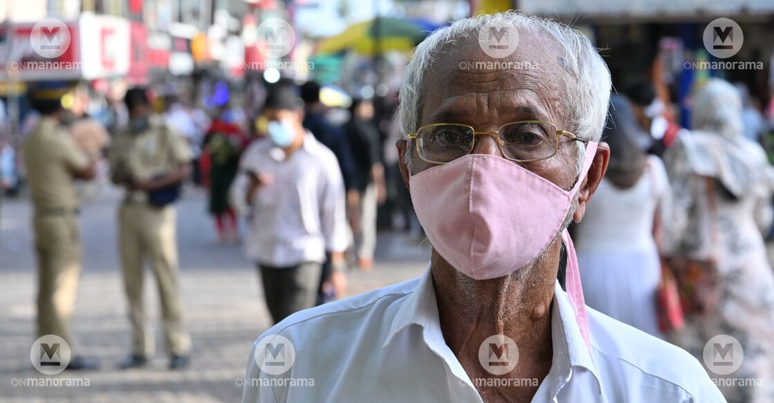A man with a mask on walks on the SM Street in Kozhikode on Wednesday. Photo: Manorama