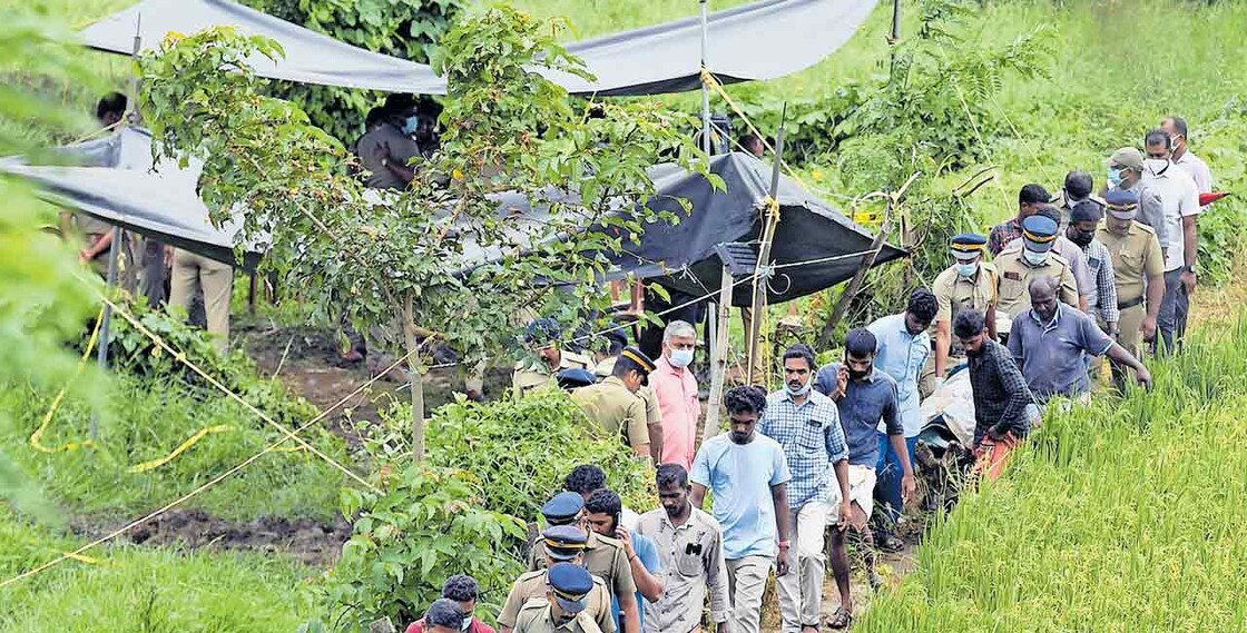 The bodies of Shijith and Satheesh being taken for postmortem after completing inquest procedures. The area near the shed is where they were found buried. Photo: Manorama