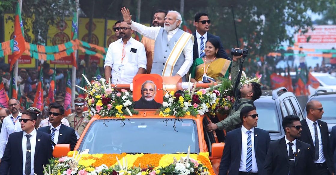 modi-suresh-gopi-thrissur-rally Suresh Gopi stands behind Prime Minister Narendra Modi on a vehicle decked up for the roadshow in Thrissur on Wednesday. Photo: Special arrangement