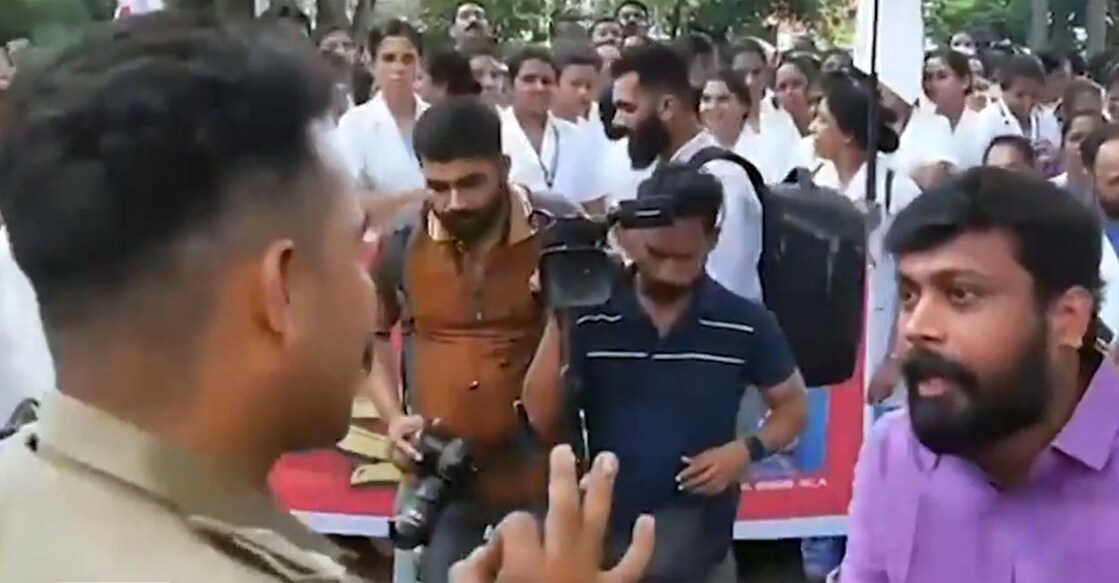 M Vijin MLA (right) argues with Kannur Town SI in the premises of the Kannur Collectorate on Thursday. Photo: Screengrab/Manorama News