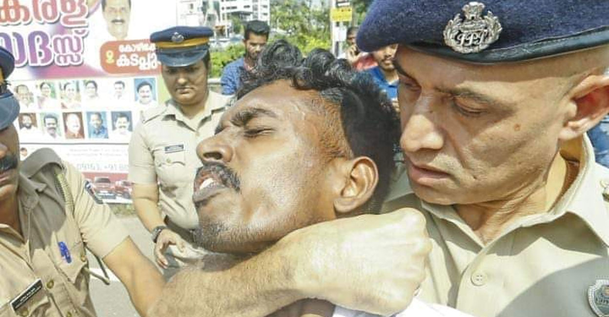 DCP K E Baiju has a KSU activist in a chokehold during a protest in Kozhikode on November 23, 2023. Photo: Facebook/@ksuCalicutDC