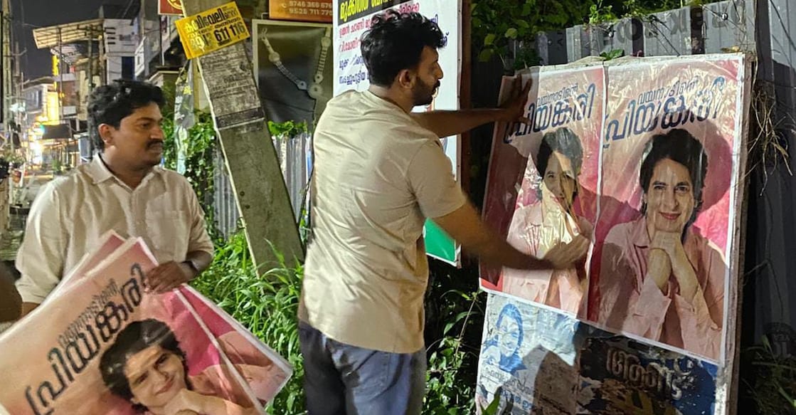 Congress workers stick posters for Priyanka Gandhi soon after the Election Commission declared the dates for the Wayanad by-poll at Kalpetta in Wayanad on Tuesday. Photo: Special arrangement.