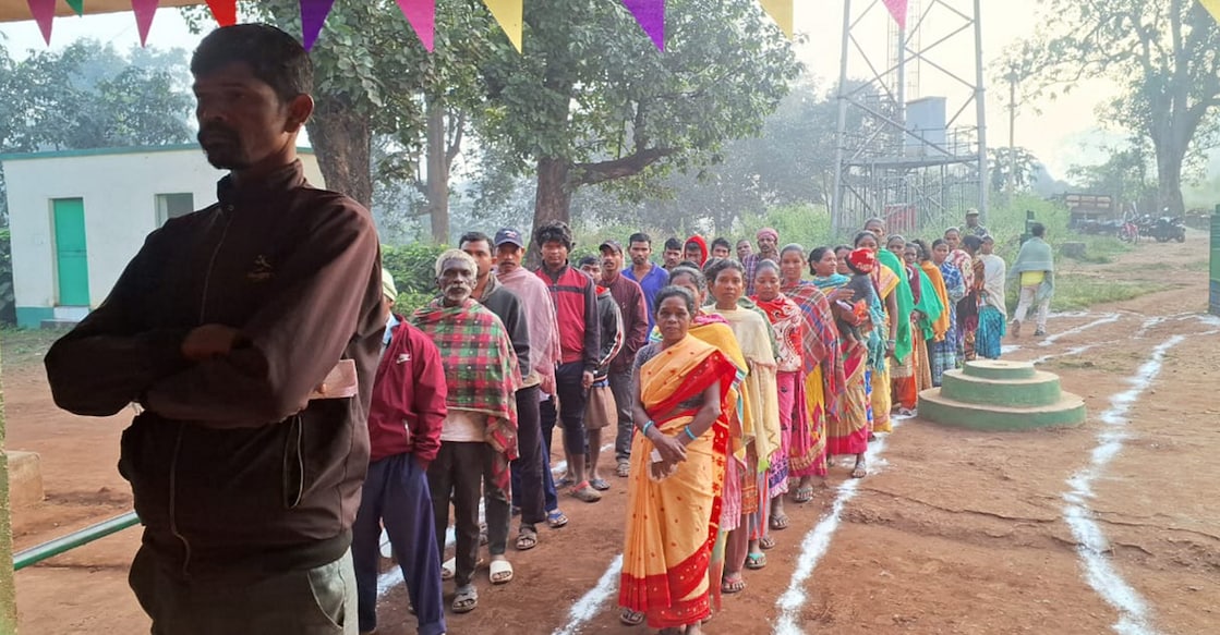 Voters wait in queues at a polling station to cast votes during the 1st phase of Jharkhand Assembly elections, in West Singhbhum district of Jharkhand. Photo: PTI