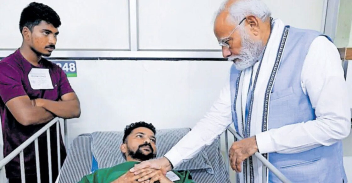 Prime Minister Narendra Modi with landslide survivor Anil Kumar. Photo: Manorama
