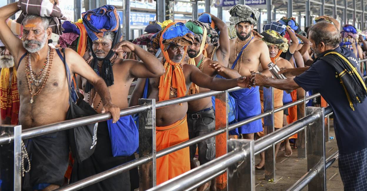 Devotees wait to climb the eighteenth steps of Sabarimala temple. Photo: PTI