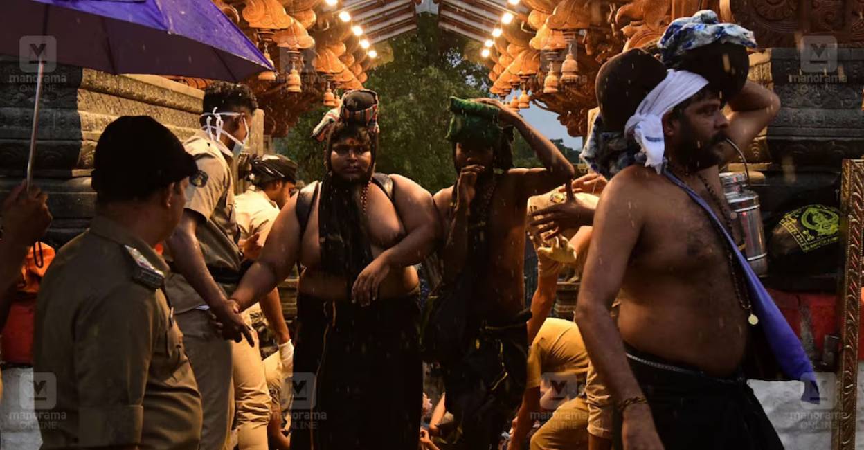 Pilgrims offer prayers at Sabarimala amid rain. Photo: Special Arrangement