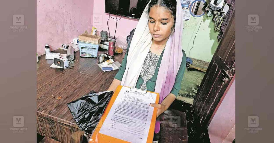 Ajna holds Nida's writing pad. Photo: Manorama