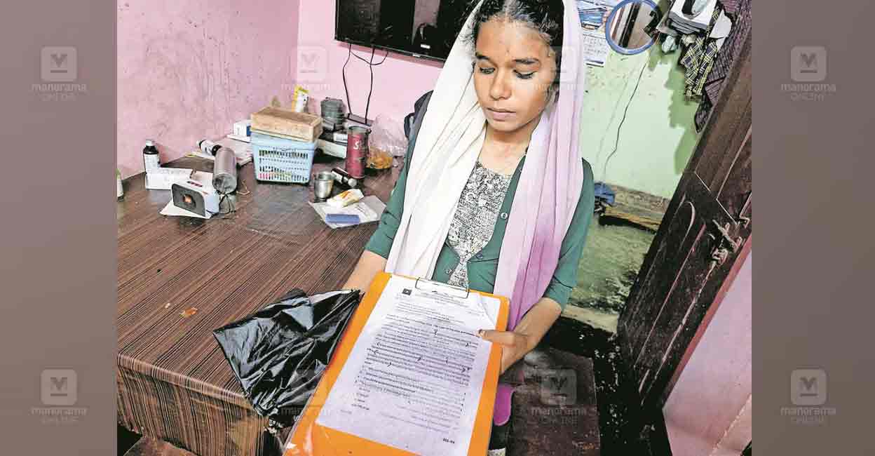 Ajna holds Nida's writing pad. Photo: Manorama