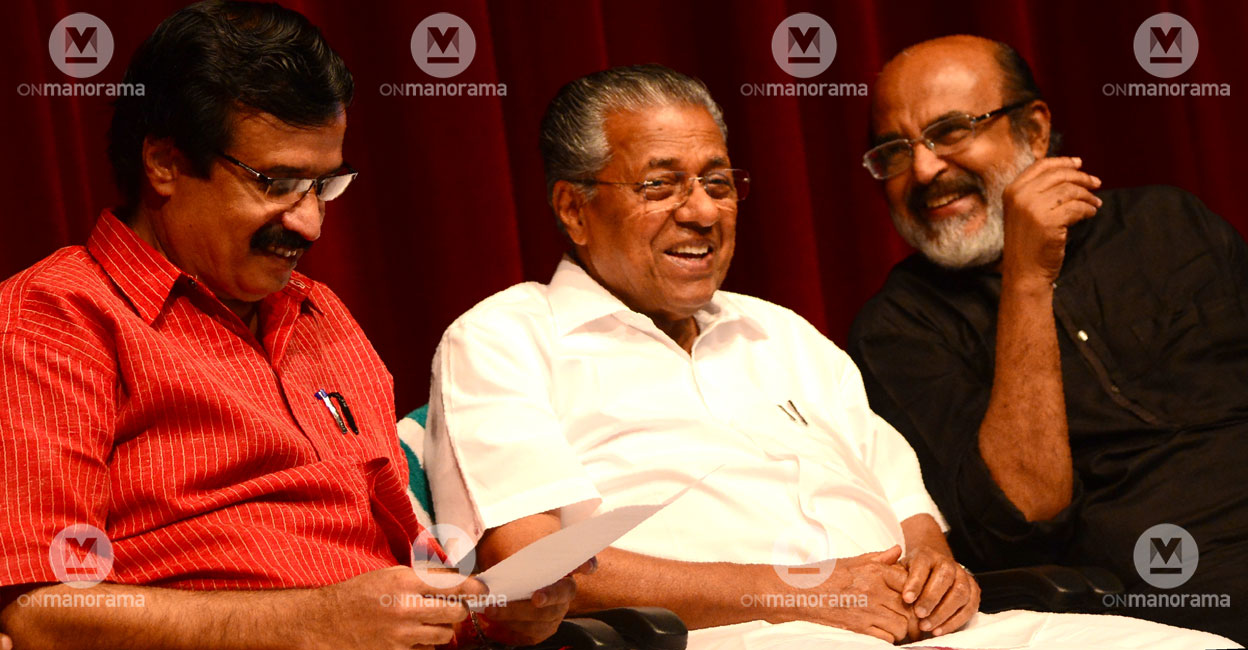 Kerala Chief Minister Pinarayi Vijayan is flanked by C Raveendranath (left) and T M Thomas Isaac. File photo: Manorama