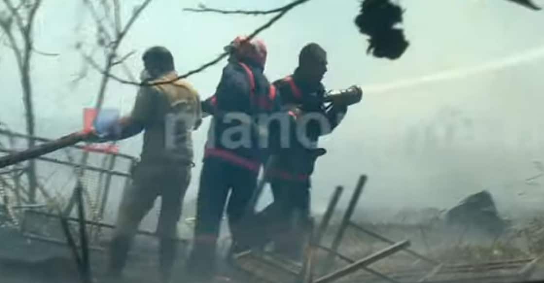 The fire, challenged by strong winds has caused considerable smoke in the area. Photo: Screengrab/ Manorama News. 