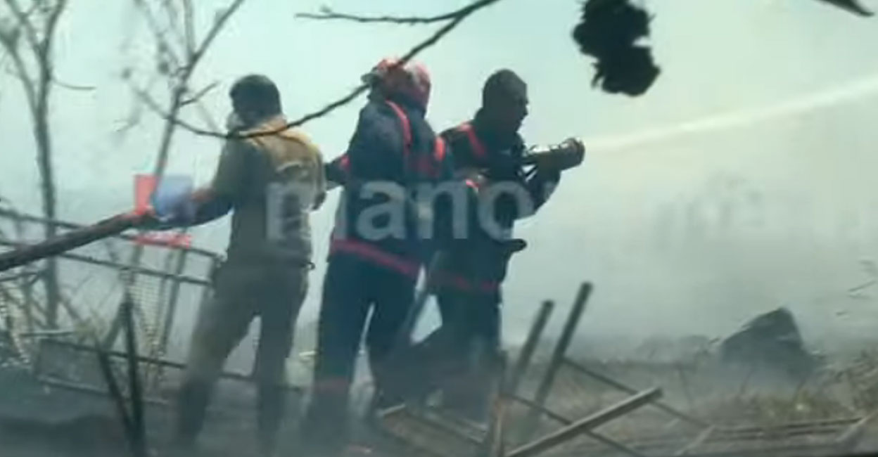 The fire, challenged by strong winds has caused considerable smoke in the area. Photo: Screengrab/ Manorama News. 