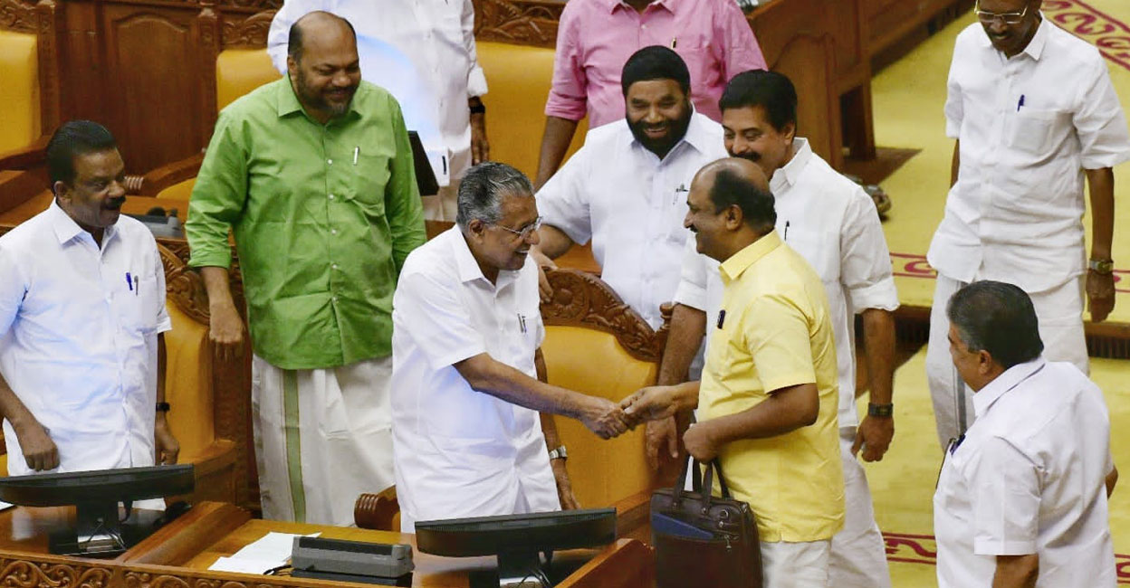 Kerala Finance Minister K N Balagopal (yellow) is greeted by Chief Minister Pinarayi Vijayan at the Assembly as he arrived to present the budget. Photo: Facebook/KNBalagopalCPIM