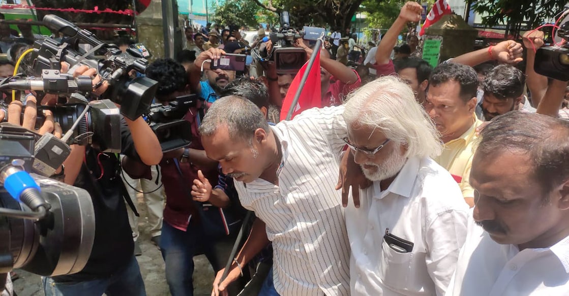 KSEU state general secretary K P Haneef accompanies security guard Sooraj Kumar, who threatened to die by suicide, to the protest venue. Photo: Onmanorama