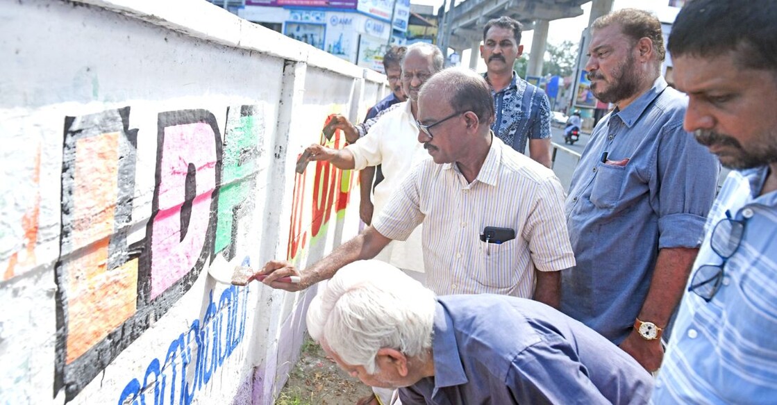LDF workers clear the walls of Ernakulam city of their election campaign materials on Sunday. Photo: Special arrangement