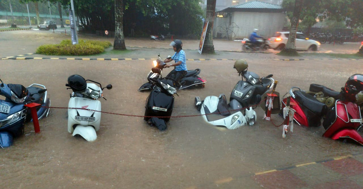 Two-wheelers parked by the road near the Infopark in Kochi were submerged in the heavy rain. Photo: Special arrangement