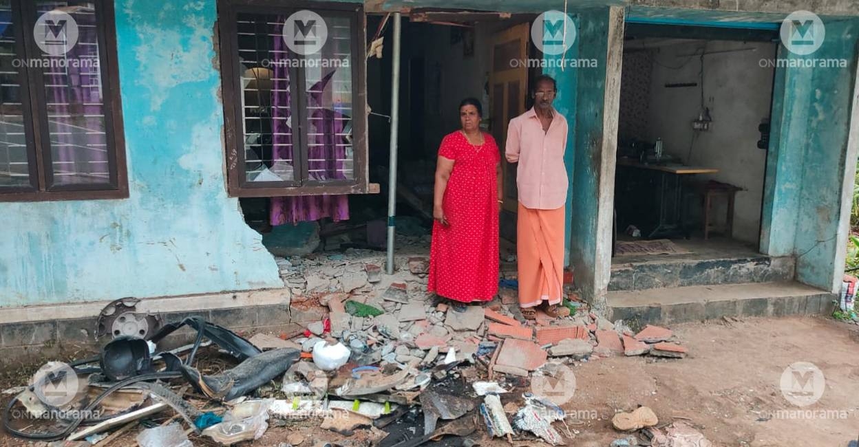 Sasidharan and wife Ramani in front of their house. Photo:  Special Arrangement