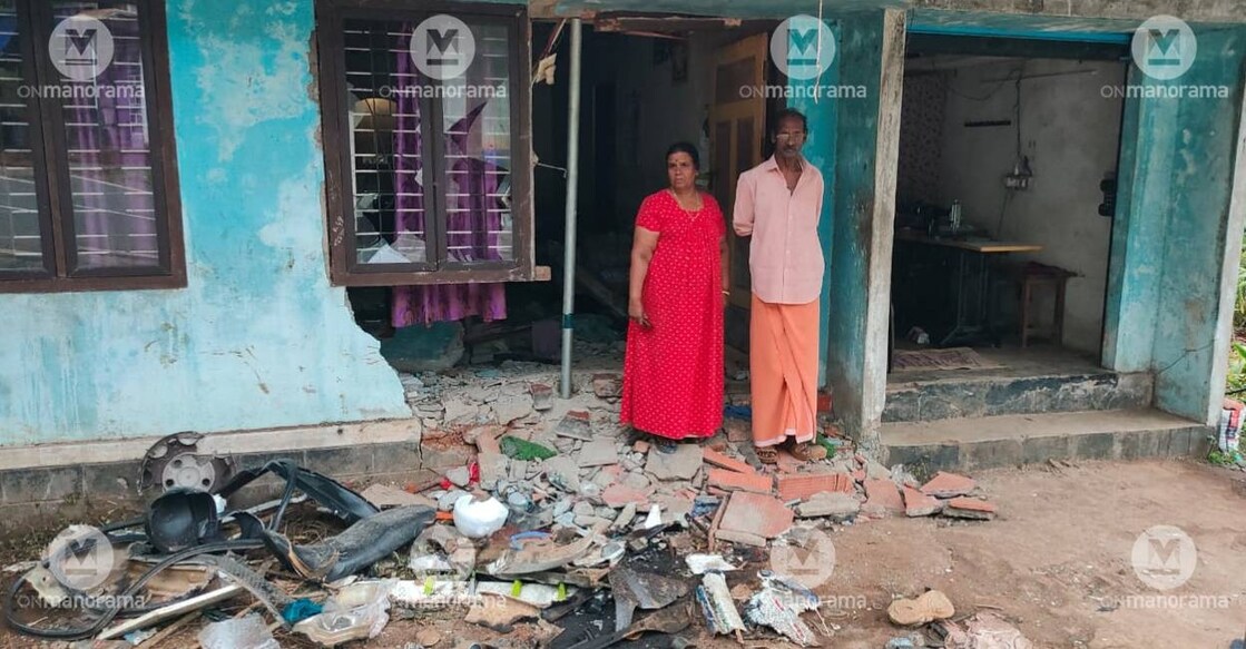 Sasidharan and wife Ramani in front of their house. Photo:  Special Arrangement