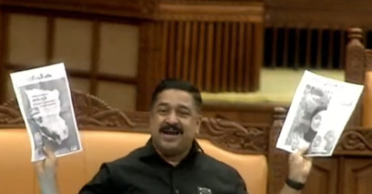 Najeeb Kanthapuram MLA shows the photostats of newspaper advertisements, given by the CPM during the Lok Sabha polls, during an Assembly session on June 20. Photo: Screengrab/SabhaTV