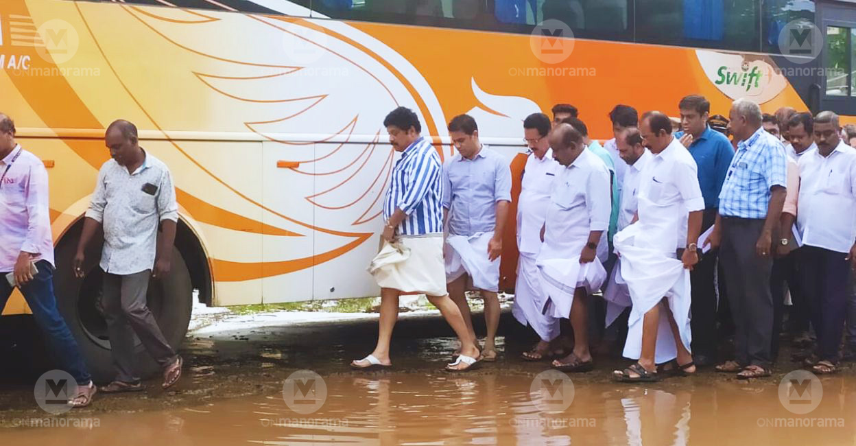 Kerala Transport Minister K B Ganesh Kumar and Hibi Eden MP avoid a waterlogged area of the KSRTC bus stand in Ernakulam as they inspect the facility on Saturday. Photo: Onmanorama
