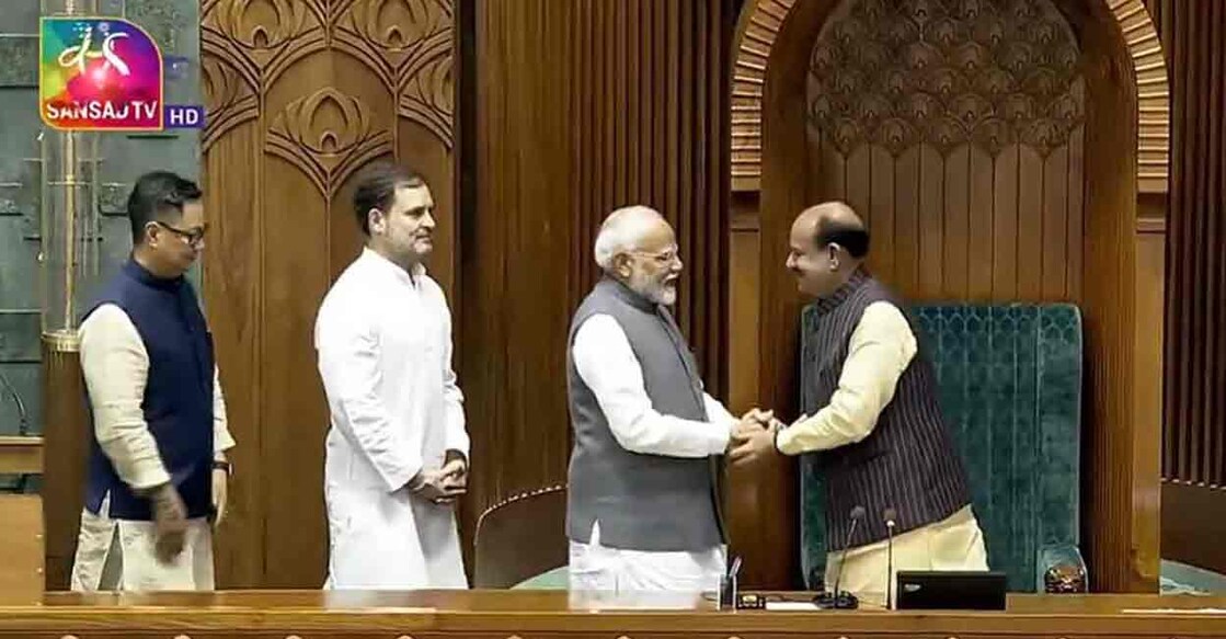 Prime Minister Narendra Modi, Leader of Opposition Rahul Gandhi and Parliamentary Affairs Minister Kiren Rijiju escort Om Birla to the Speaker's chair. Photo: Screengrab/Sabha TV