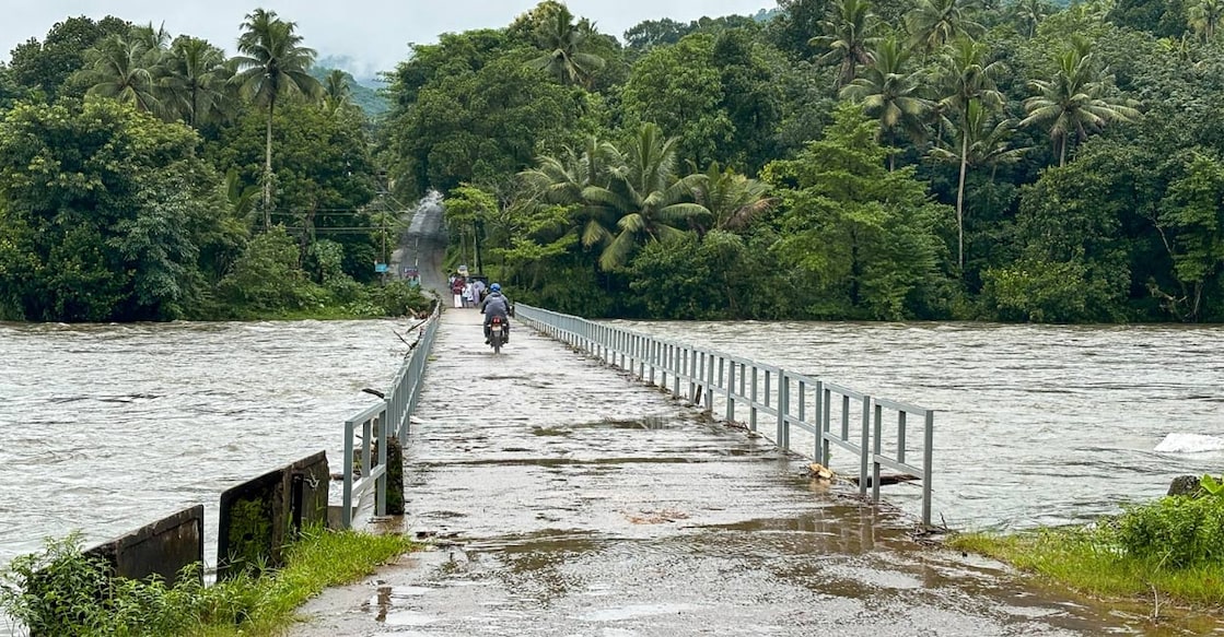 As the river swells, it submerges the concrete bridge, the sole line of connectivity for Arayanjilimon residents to the outside world. Photo: Tijin VS. 