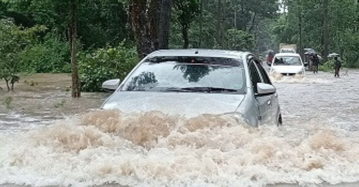 A car is driven through a flooded Kozhikode-Bengaluru National Highway (NH 766). Photo: Special arrangement